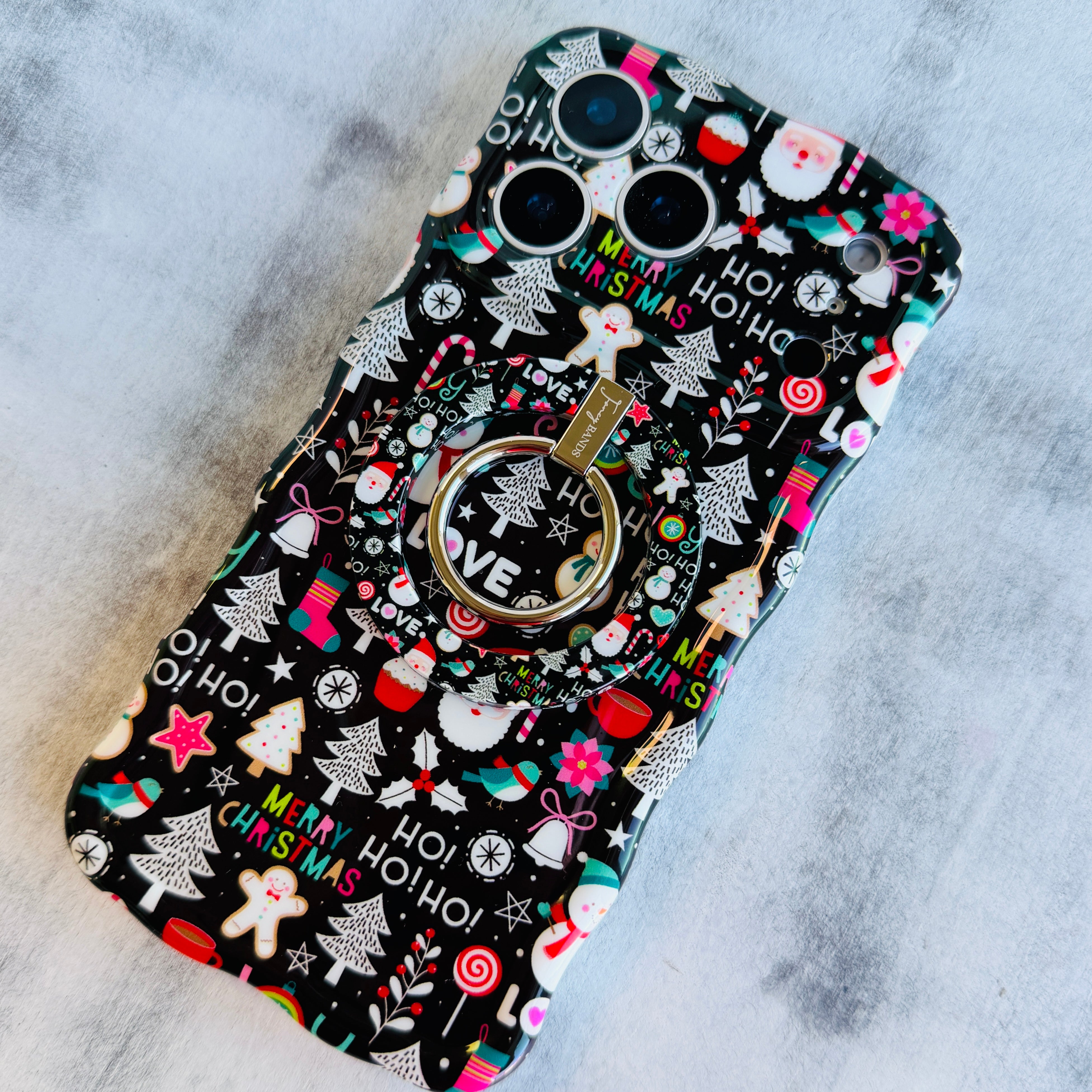 Phone case with Christmas-themed design on a gray surface