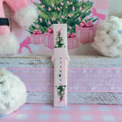 Pretty in PinkMas Samsung Galaxy Watch band assembled and standing upright, pink and white stripes with two bow-tied trees