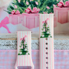 Both straps of the Pretty in PinkMas silicone Samsung Galaxy Watch band standing up in front of pink gift boxes