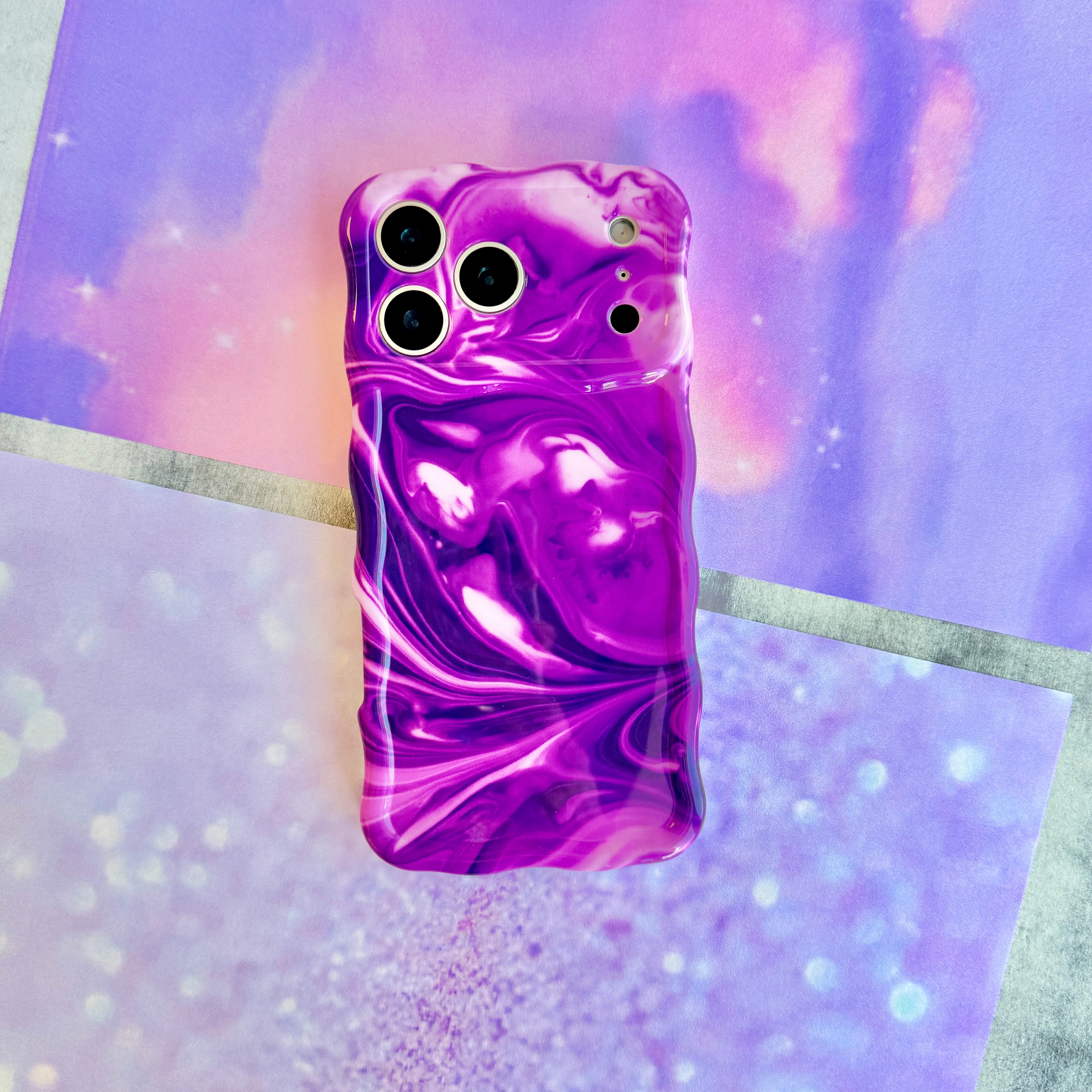 Grape Crush Wavy Luxe MagSafe iPhone case with a glossy purple liquid marble swirl design from Fancy Bands