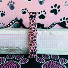 Pretty Little Paws Apple Watch band with black paw prints and polka dot bow on pink background with paw decorations
