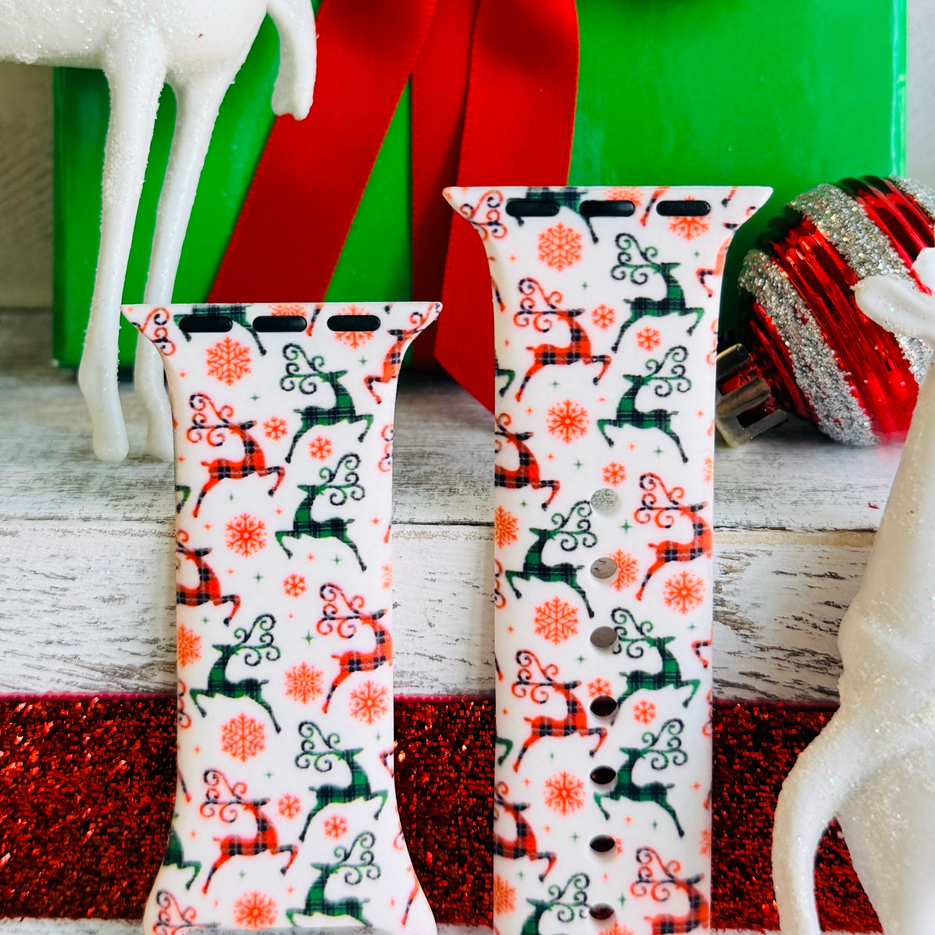 Close-up of Reindeer Waltz print showing playful dancing reindeer and coral snowflakes on Apple Watch silicone band
