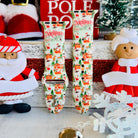 North Pole Apple Watch band displayed with Santa Claus decorations and festive North Pole props
