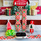 Merry Tartan Apple Watch band with red, green, and white plaid pattern styled with Farm Fresh Christmas Trees sign
