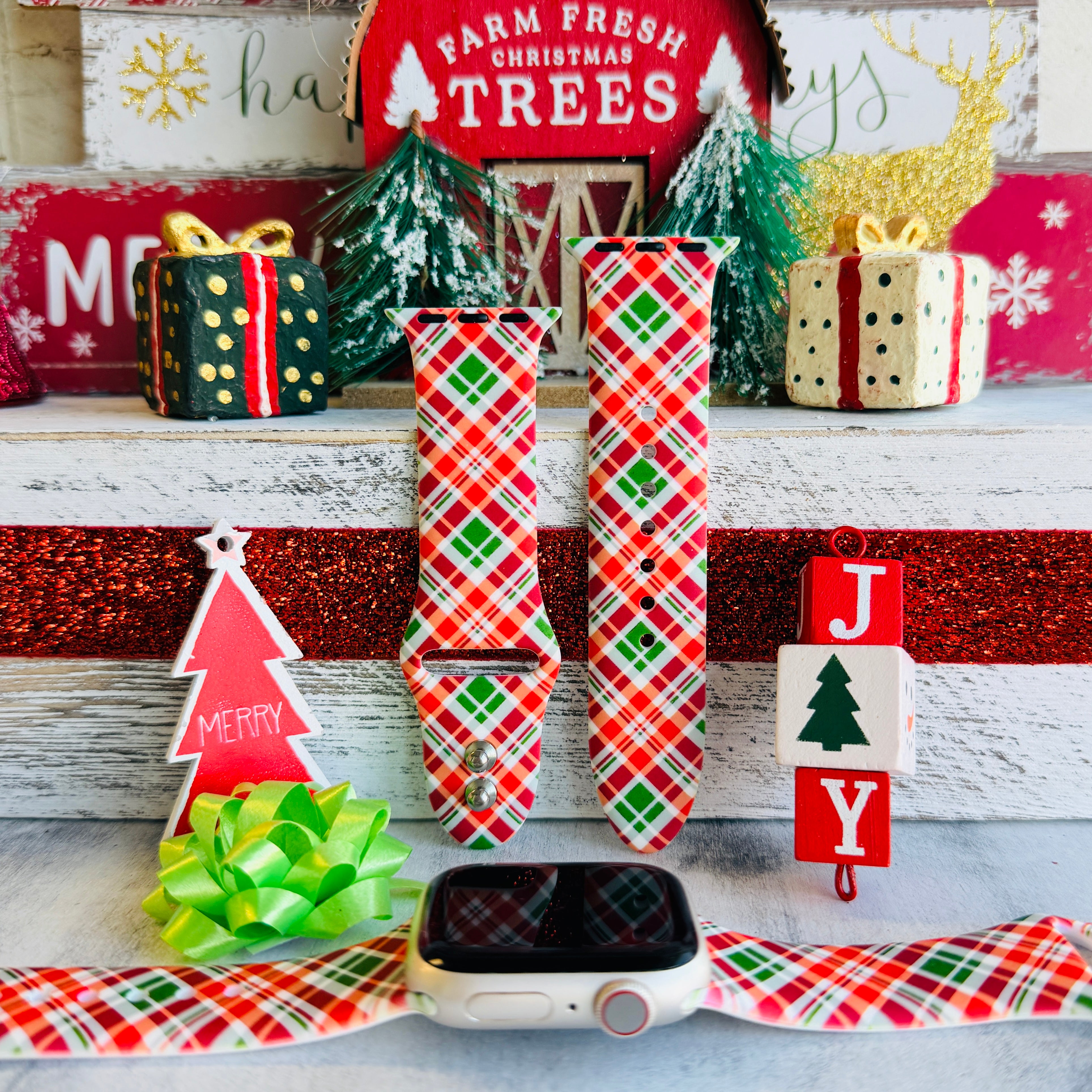Merry Tartan Apple Watch band with red, green, and white plaid pattern styled with Farm Fresh Christmas Trees sign
