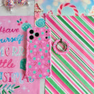Peppermint Cutie MagSafe grip ring beside the matching iPhone case on pink, green and white candy stripe paper