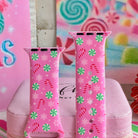 Both straps of the Peppermint Cutie silicone Apple Watch band standing on a pink box in front of a candy backdrop