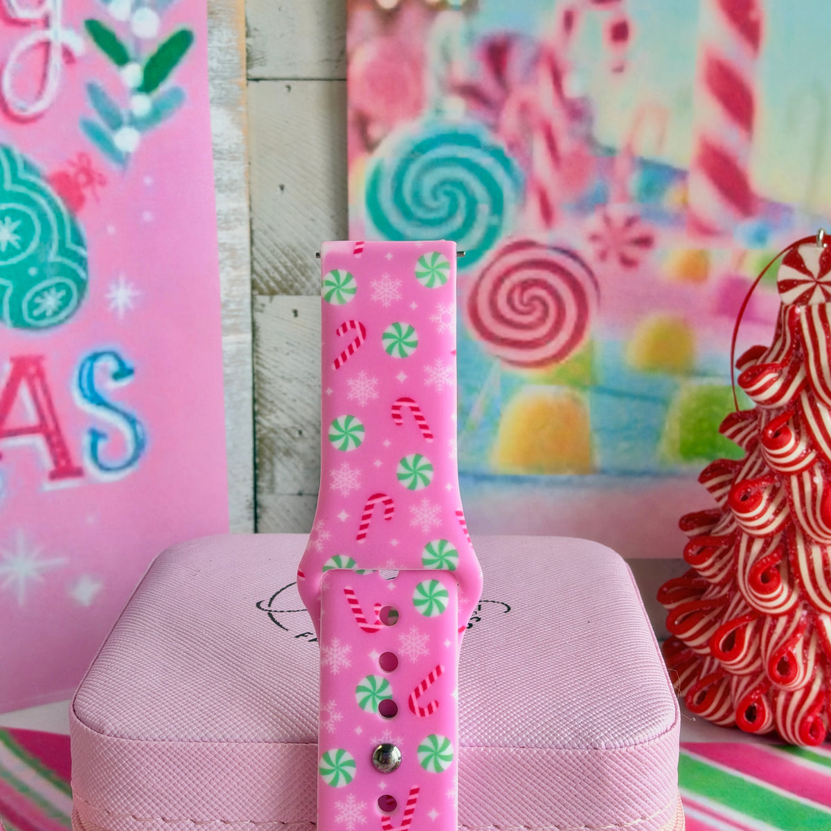 Close-up of the Peppermint Cutie Samsung watch band showing mint peppermints, candy canes and snowflakes on pink