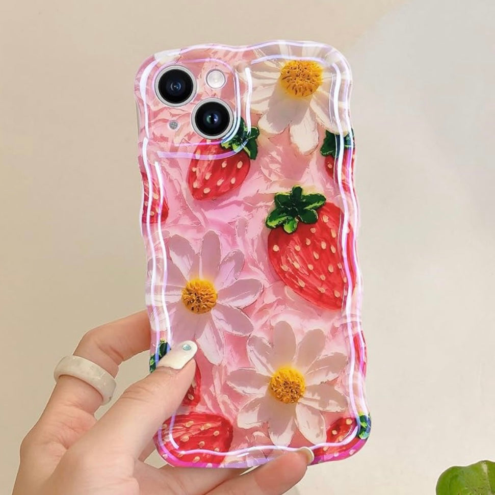Hand holding the Berry Cute Blooms Wavy Luxe MagSafe iPhone case, painted red strawberries and white daisies on a soft pink ground
