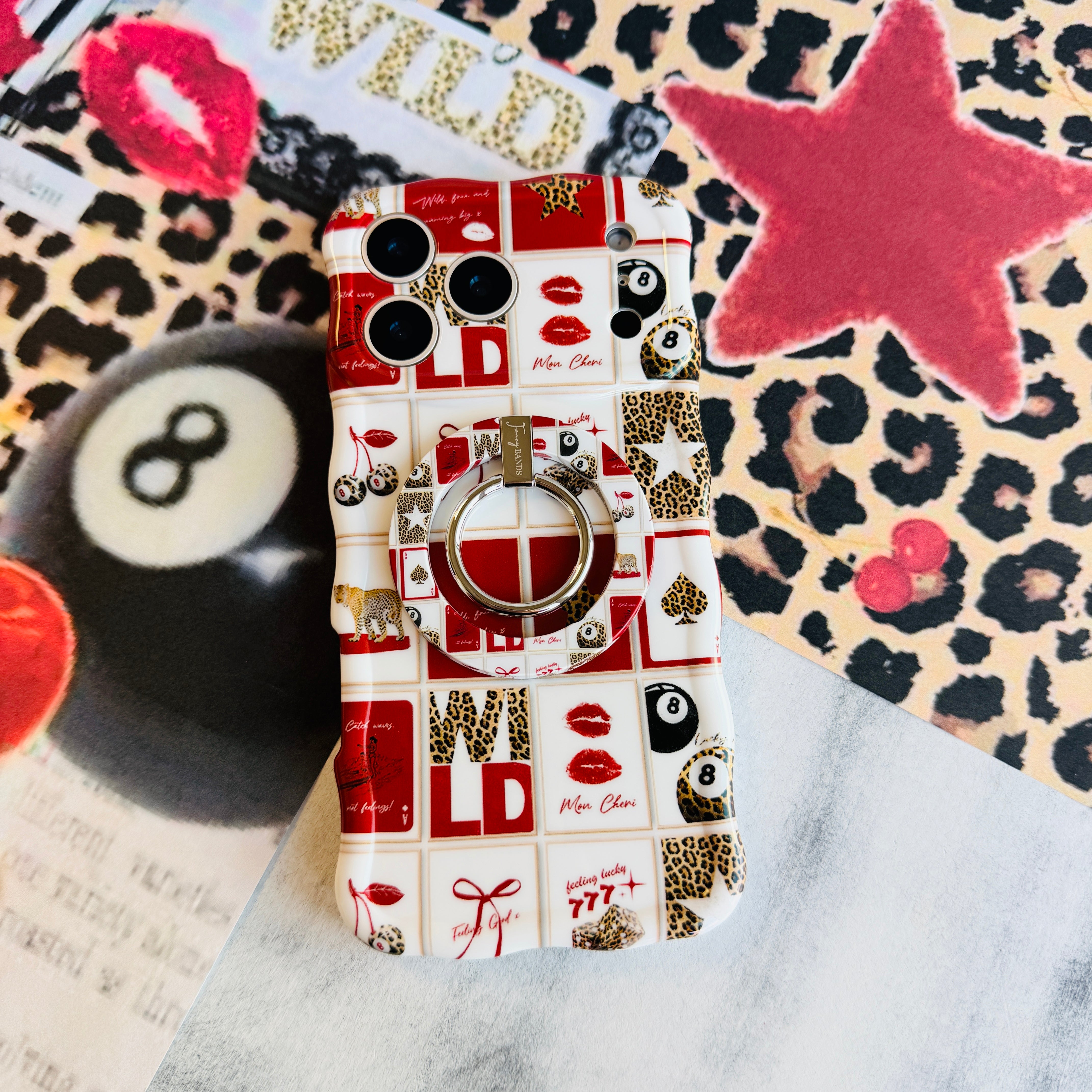 Wild Cherry collage pattern MagSafe phone grip ring with leopard print cherries, 8-balls, and playing cards on a red and white background
