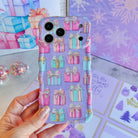 Hand holding the No Peeking, Darling Wavy Luxe MagSafe iPhone case, pastel pink, aqua and striped gift boxes with gold bows on lavender