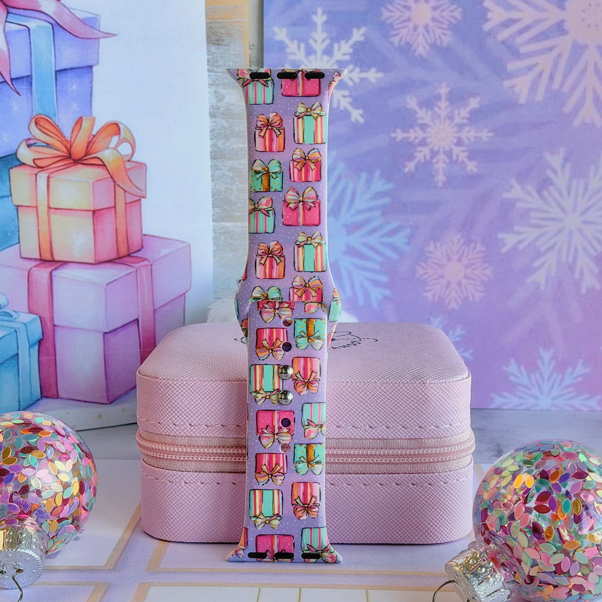 No Peeking, Darling Apple Watch band buckled and standing on a pink jewelry box between glitter ornaments