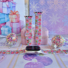No Peeking, Darling Apple Watch band shown on an Apple Watch and as two straps on a pink jewelry box, pastel presents on lavender