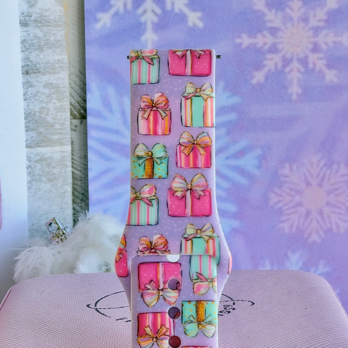Close-up of a single No Peeking, Darling Samsung watch band strap, pastel presents with gold bows on lavender