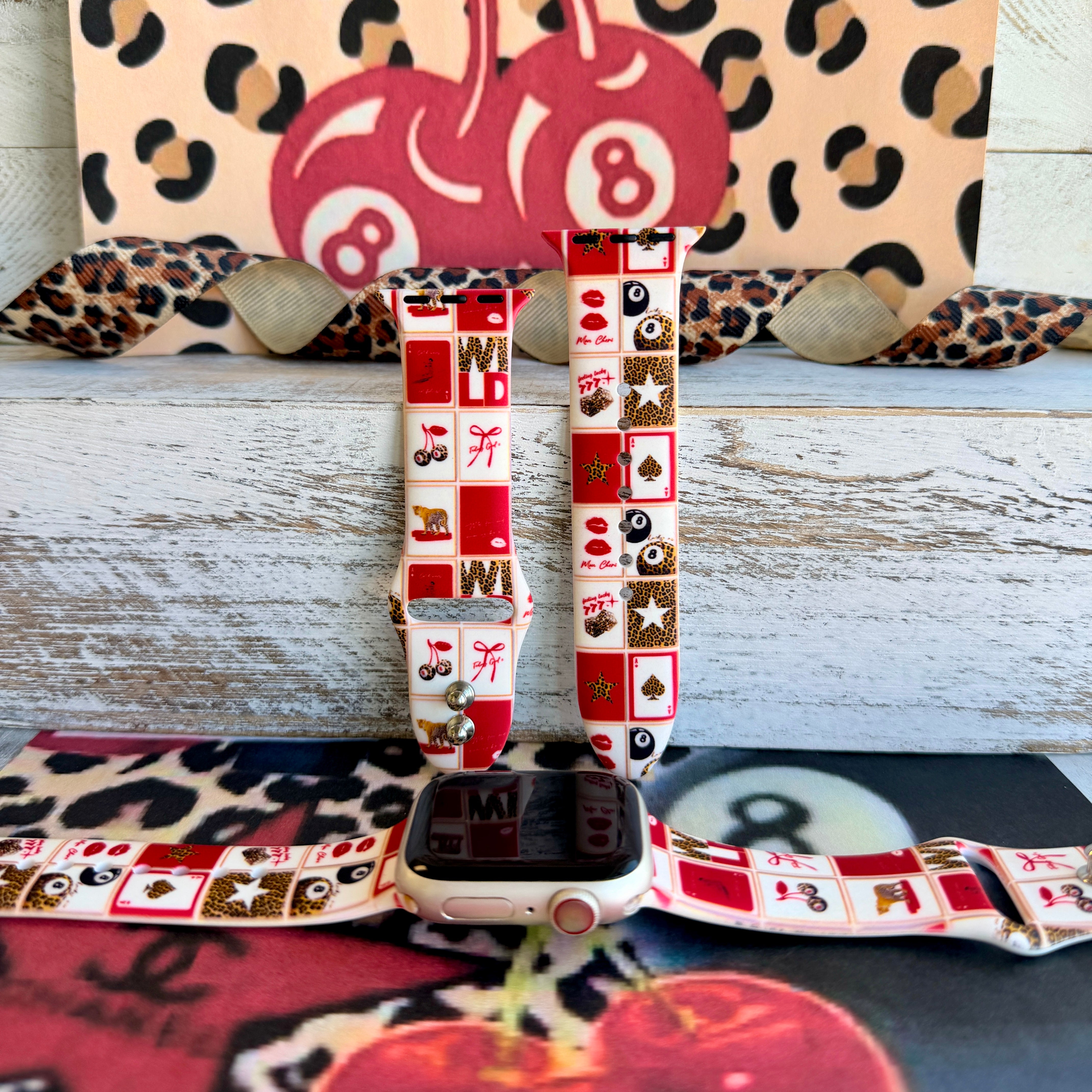 Wild Cherry Apple Watch band with retro checkerboard pattern featuring cherries, lips, and leopard print in red and cream
