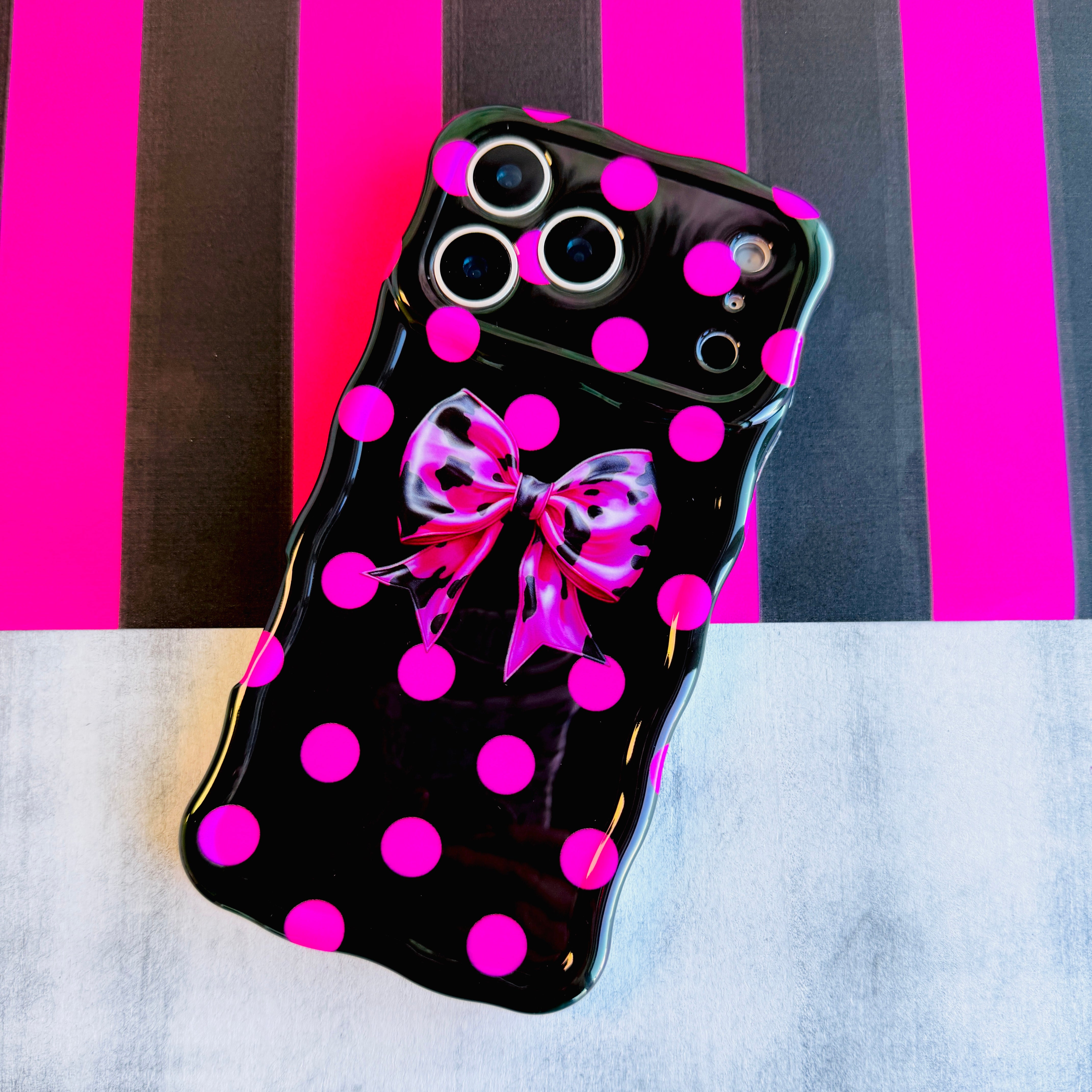 Sweet Spot MagSafe iPhone case with hot pink polka dots and cowhide bow on black by Fancy Bands
