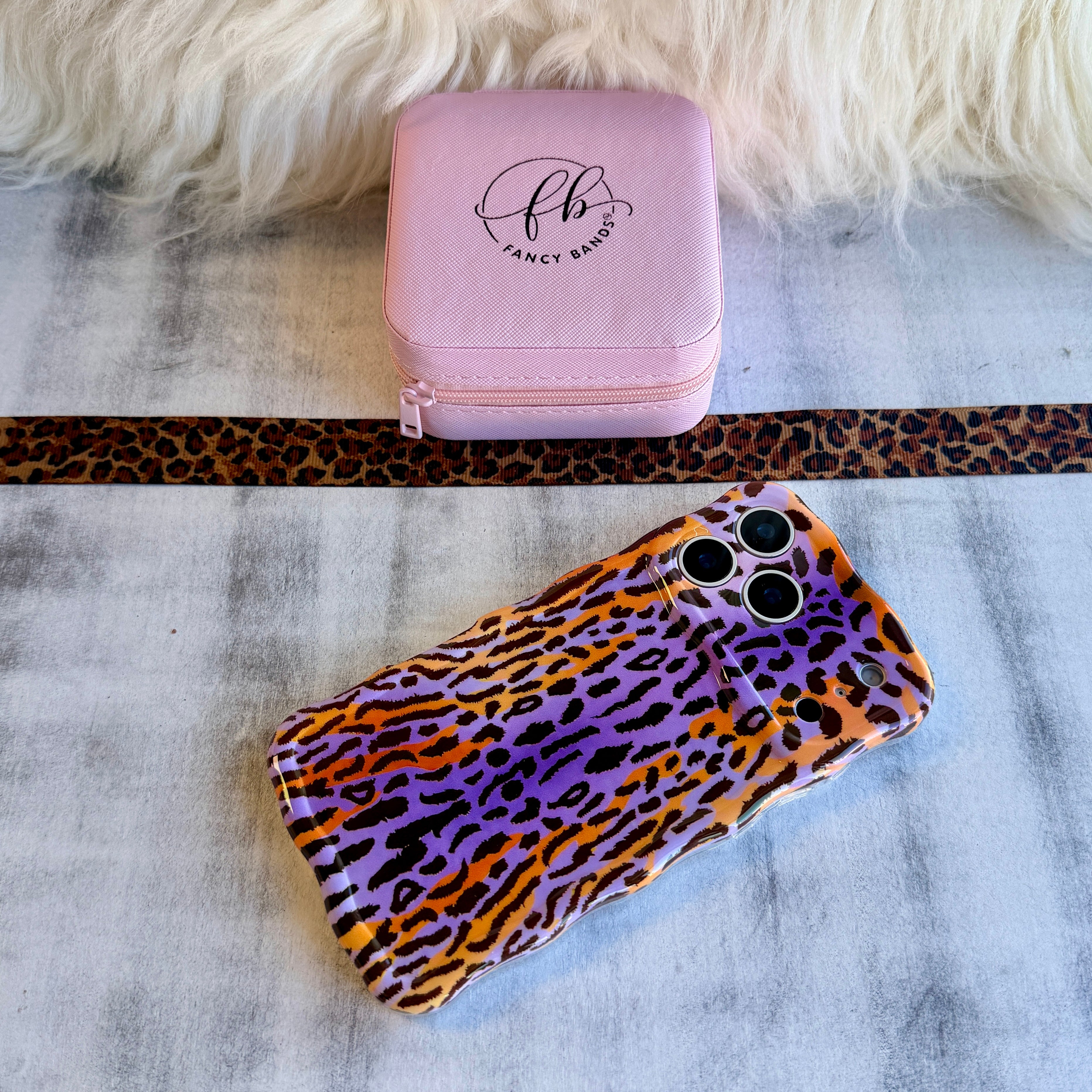 Purr-ple Haze MagSafe iPhone case with purple and orange leopard print by Fancy Bands
