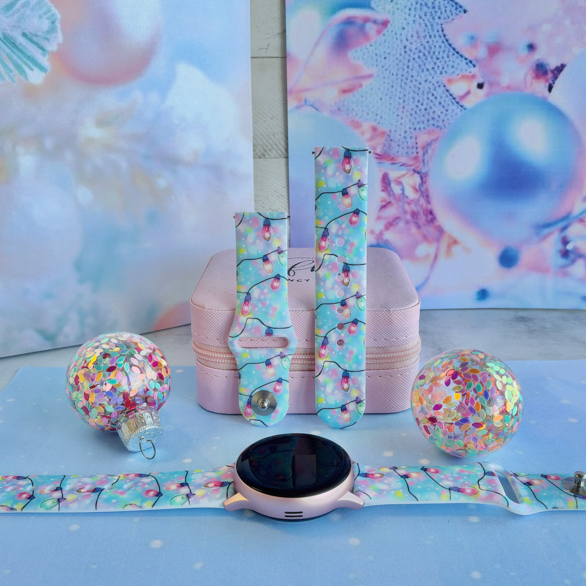 Twinkle All The Way Samsung Galaxy Watch band on a rose gold Galaxy Watch, with both straps on a pink jewelry box