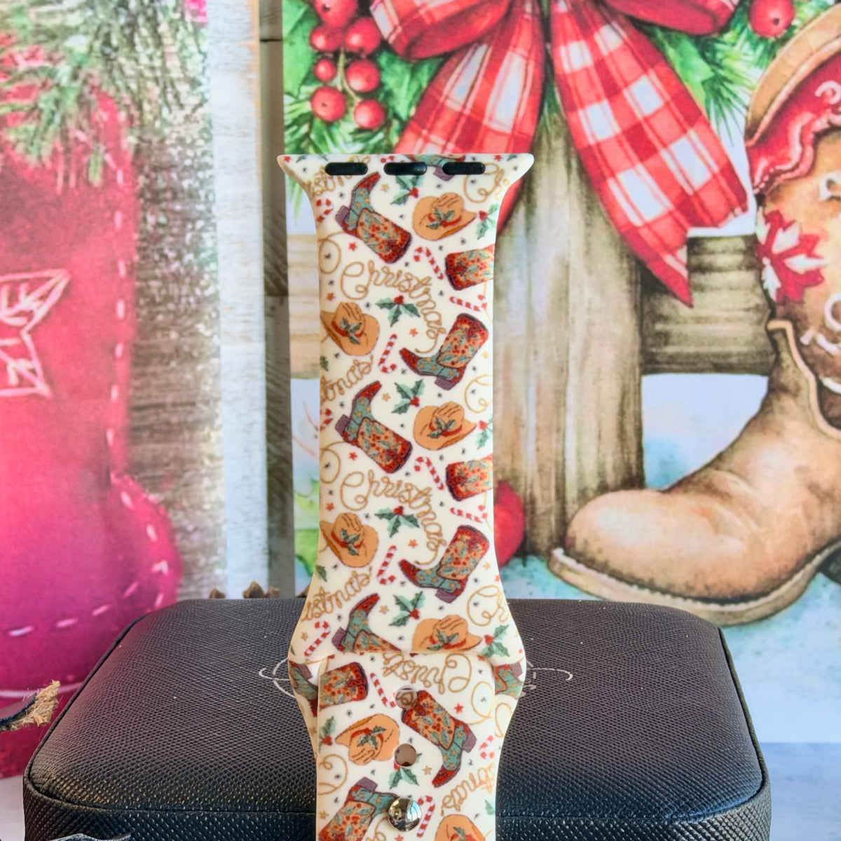 Close-up of a single Boot Scootin' Christmas Apple Watch band strap, western Christmas print on cream