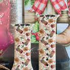 Close-up of both Boot Scootin' Christmas Apple Watch band straps with cowboy boots, tan hats, candy canes and lasso Christmas lettering