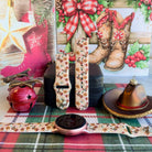 Boot Scootin' Christmas Samsung Galaxy Watch band on a rose gold Galaxy Watch, with both straps on a black jewelry box