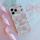 Trendy blush pink and white wavy iPhone case featuring a classical Toile de Jouy estate and landscape pattern with a high-gloss finish.