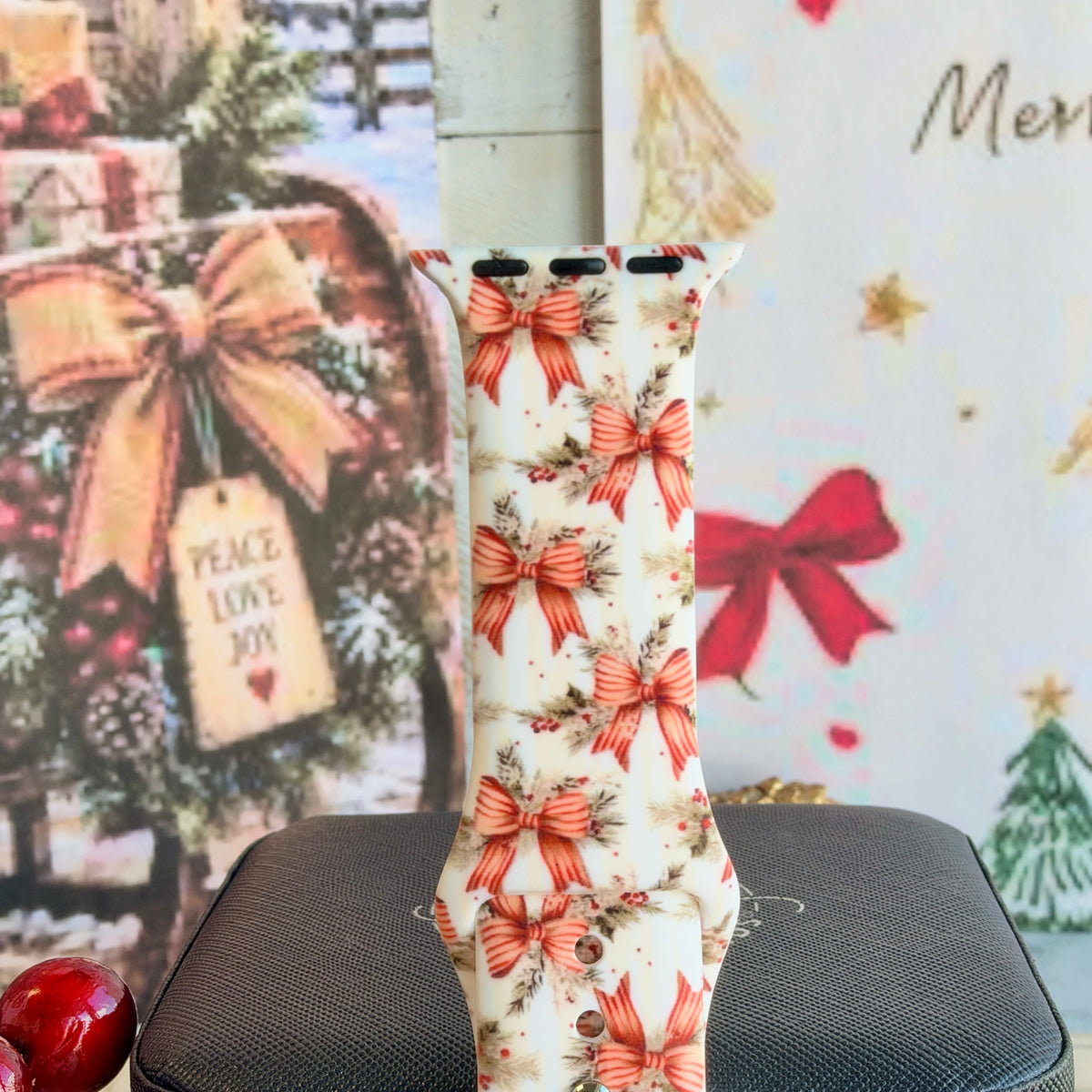 Close-up of a single Deck Yourself in Bows & Holly Apple Watch band strap, vintage Christmas bow print on ivory