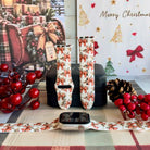 Deck Yourself in Bows & Holly Apple Watch band shown on an Apple Watch and as two straps on a black jewelry box, red ribbon bows and holly on ivory