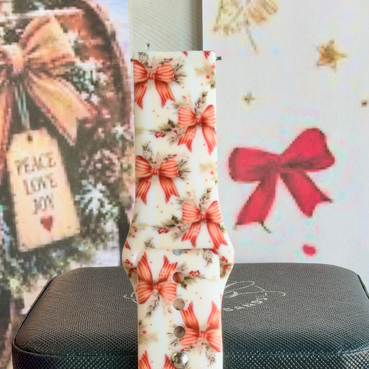 Close-up of a single Deck Yourself in Bows & Holly Samsung watch band strap, vintage Christmas bow print on ivory