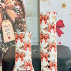 Close-up of both Deck Yourself in Bows & Holly Samsung Galaxy Watch band straps with striped red ribbon bows and holly on ivory