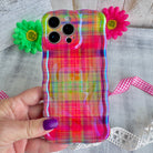Hand holding the Hazy Tartan Wavy Luxe MagSafe iPhone case, soft-focus rainbow plaid in pink, lime and marigold