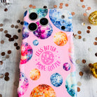Pink wavy iPhone case featuring colorful retro disco balls and the quote Less Bitter More Glitter, held in hand with MagSafe compatibility.