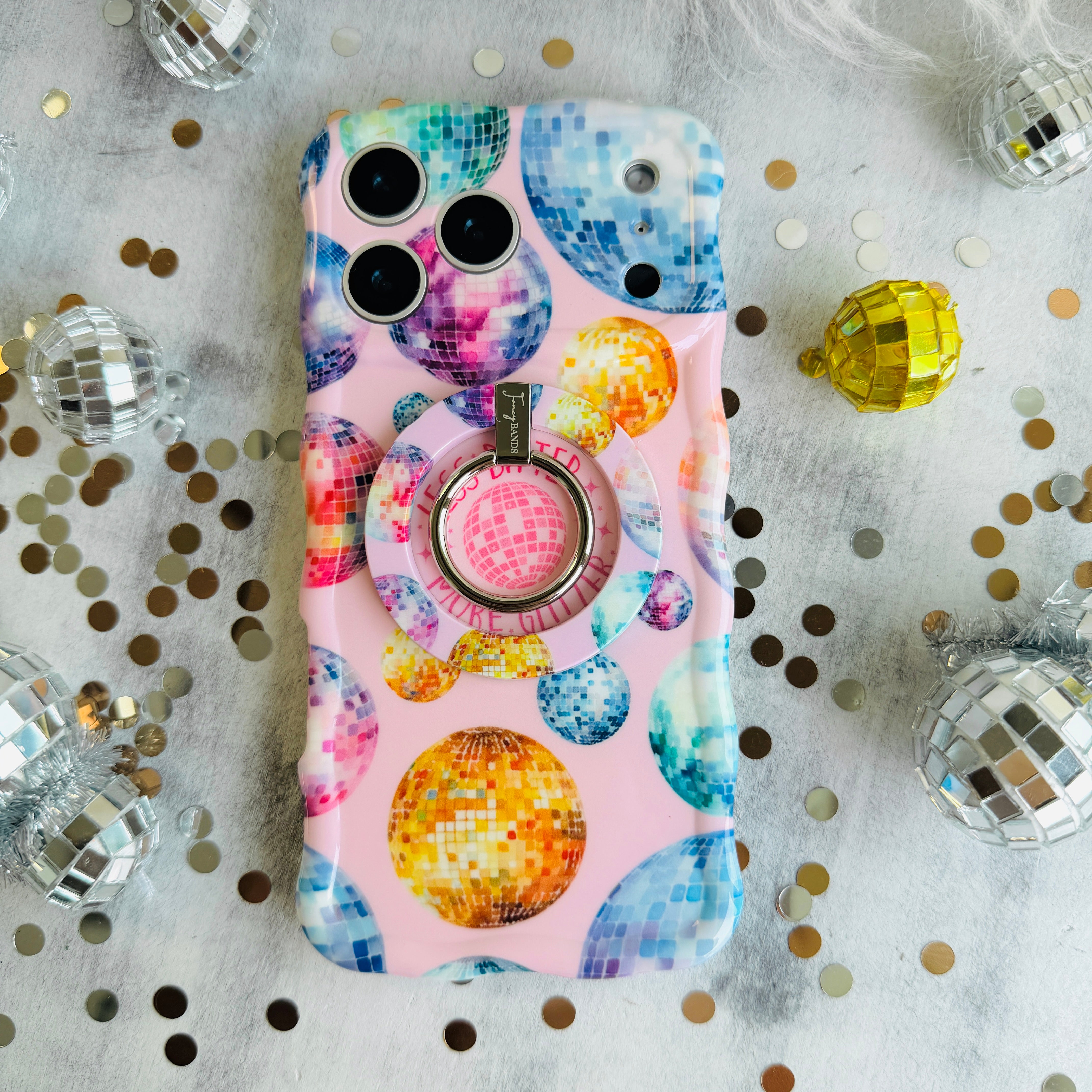 Colorful disco ball pattern MagSafe phone grip ring and stand on pink background compatible with iPhone and Samsung