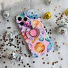 Colorful disco ball pattern MagSafe phone grip ring and stand on pink background compatible with iPhone and Samsung