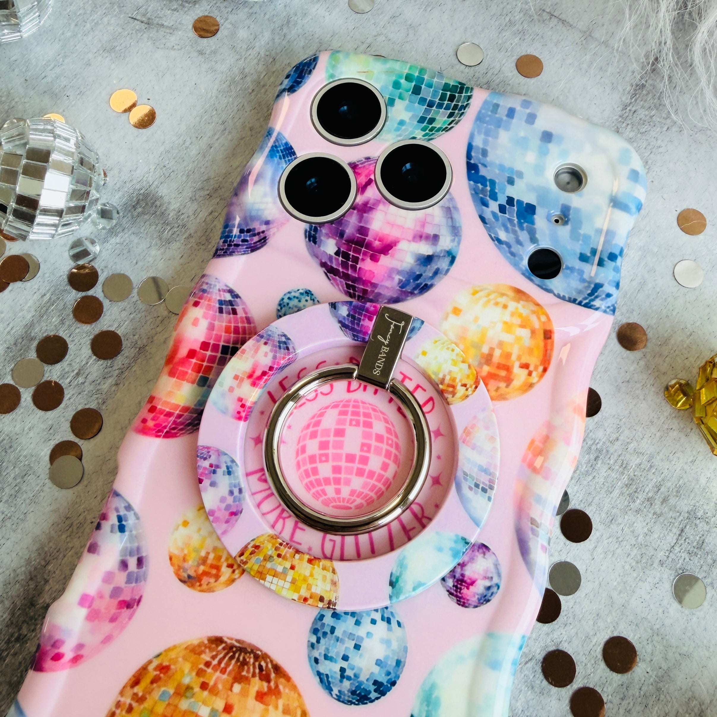 Colorful disco ball pattern MagSafe phone grip ring and stand on pink background compatible with iPhone and Samsung