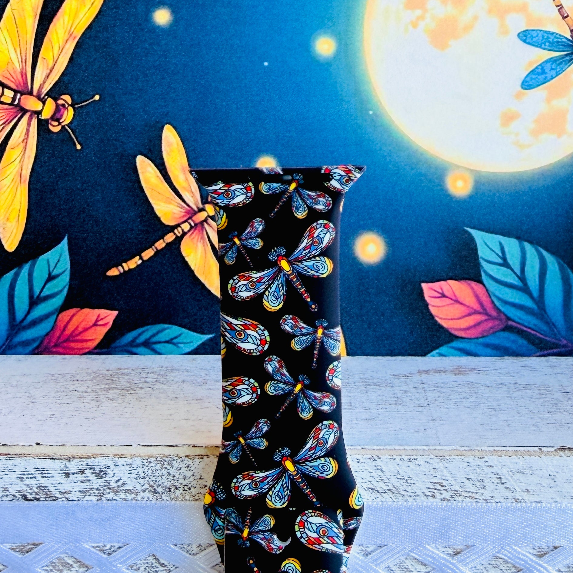 Dragonfly Dreams Apple Watch band with colorful paisley-wing dragonflies on black background with moon and nature backdrop
