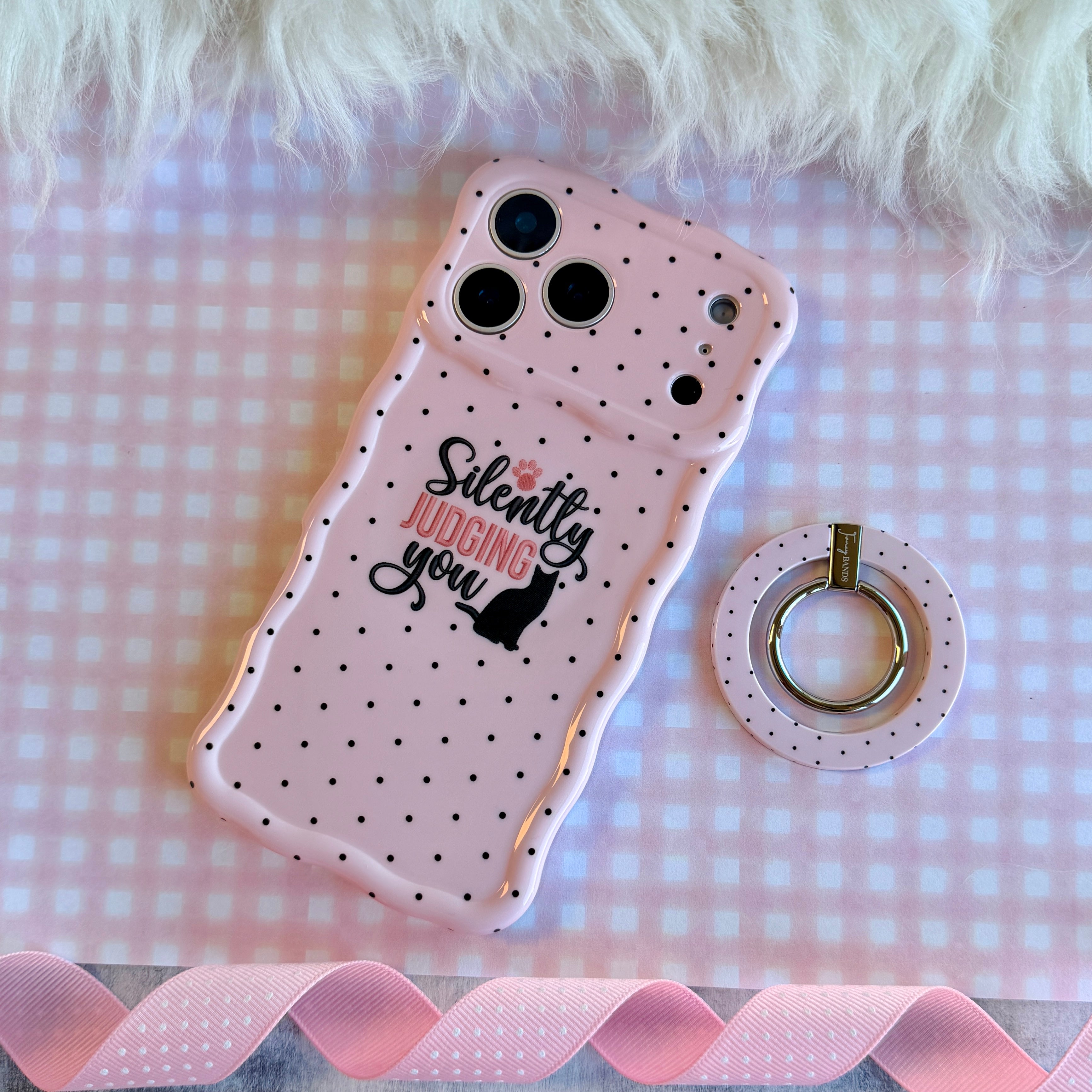 Silently Judging You soft pink MagSafe phone grip ring with small black polka dots compatible with iPhone and Samsung