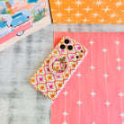 Desert Starburst retro mid-century MagSafe phone grip ring with pink and orange starbursts on a cream background compatible with iPhone and Samsung