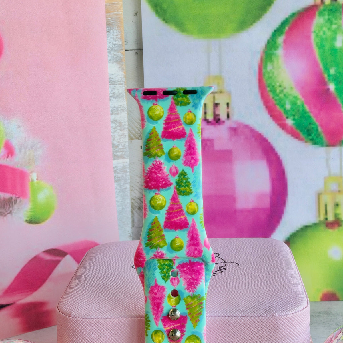 Close-up of a single Merry & Bright, Totally! Apple Watch band strap, pink and green Christmas tree print on aqua