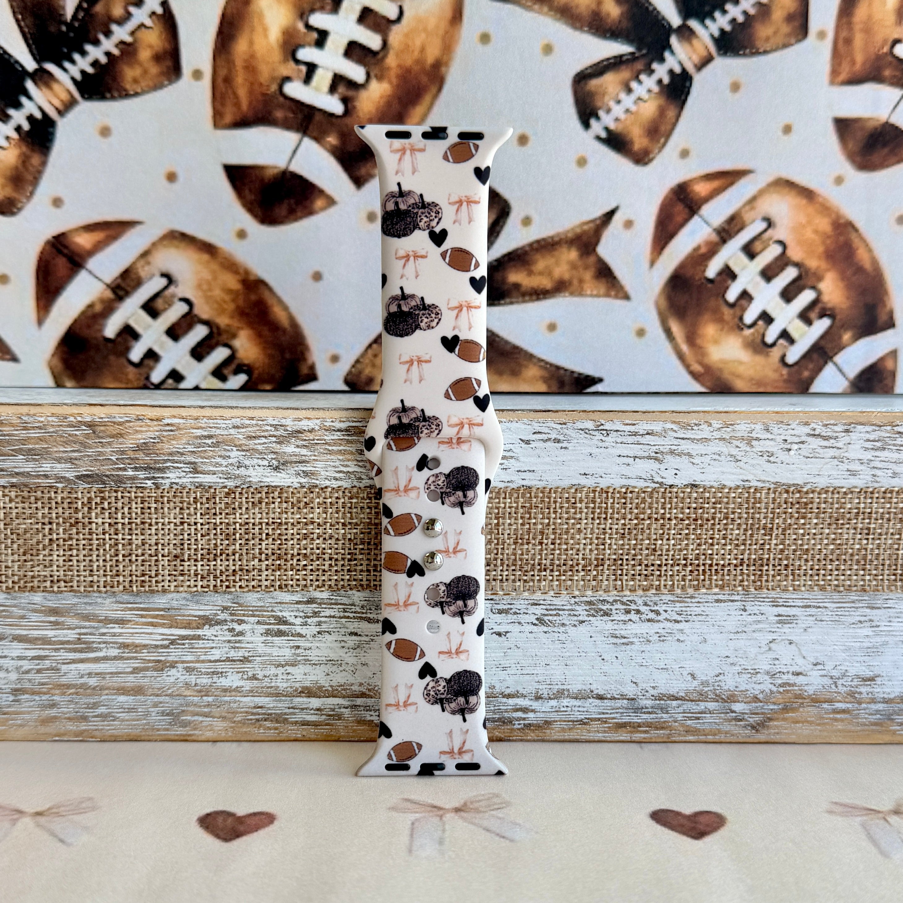 Game Day Darling coquette football print silicone band for Apple Watch with footballs, pumpkins, bows and hearts from Fancy Bands