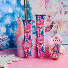 Sugarplum Square Apple Watch band buckled and standing on a pink jewelry box beside a confetti ornament and a pink gingerbread house