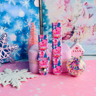 Both straps of the Sugarplum Square silicone Samsung Galaxy Watch band on a pink jewelry box beside a confetti ornament