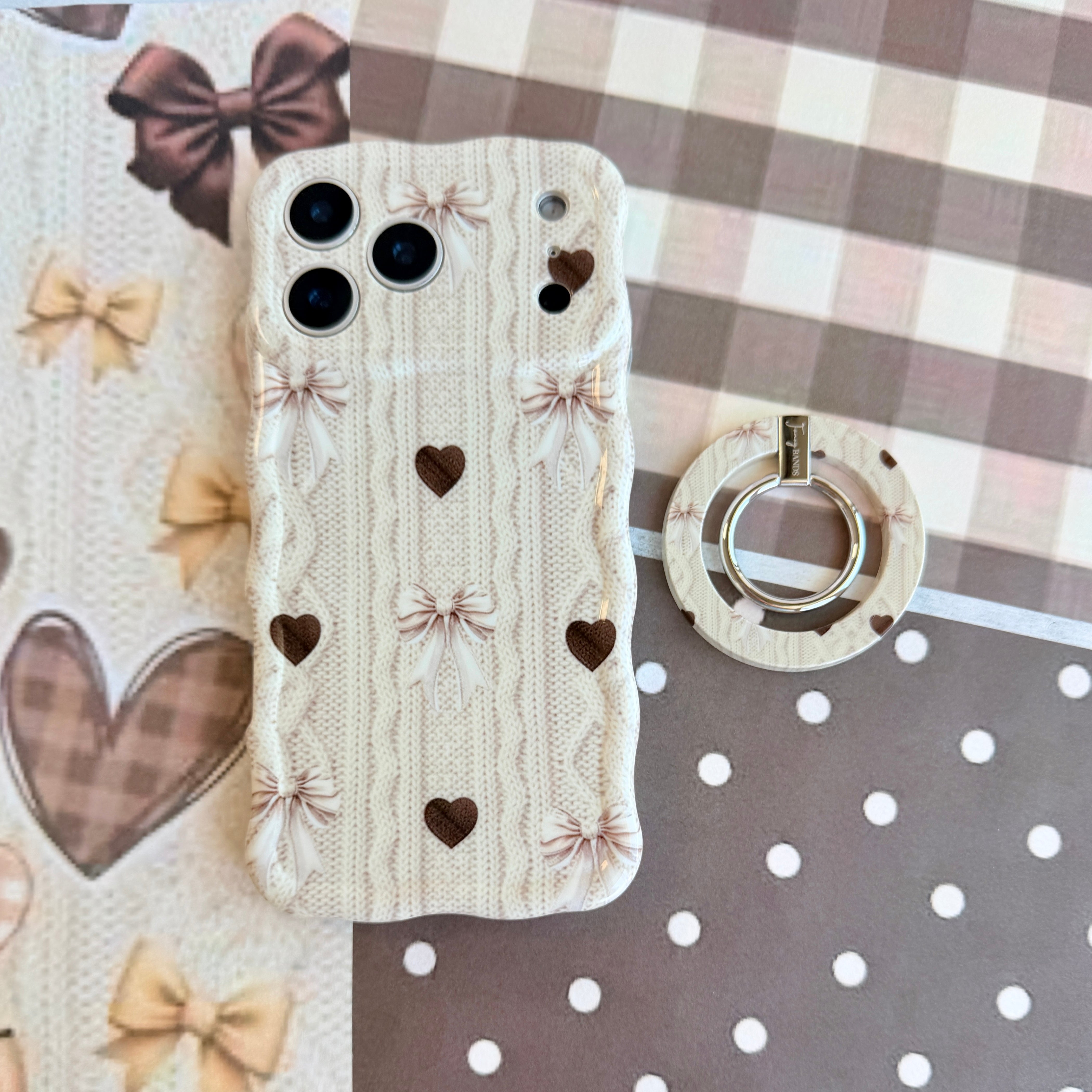 Sweater Weather Sweetheart MagSafe grip ring in kickstand mode propping up a phone hands-free with the cozy cable-knit print visible.