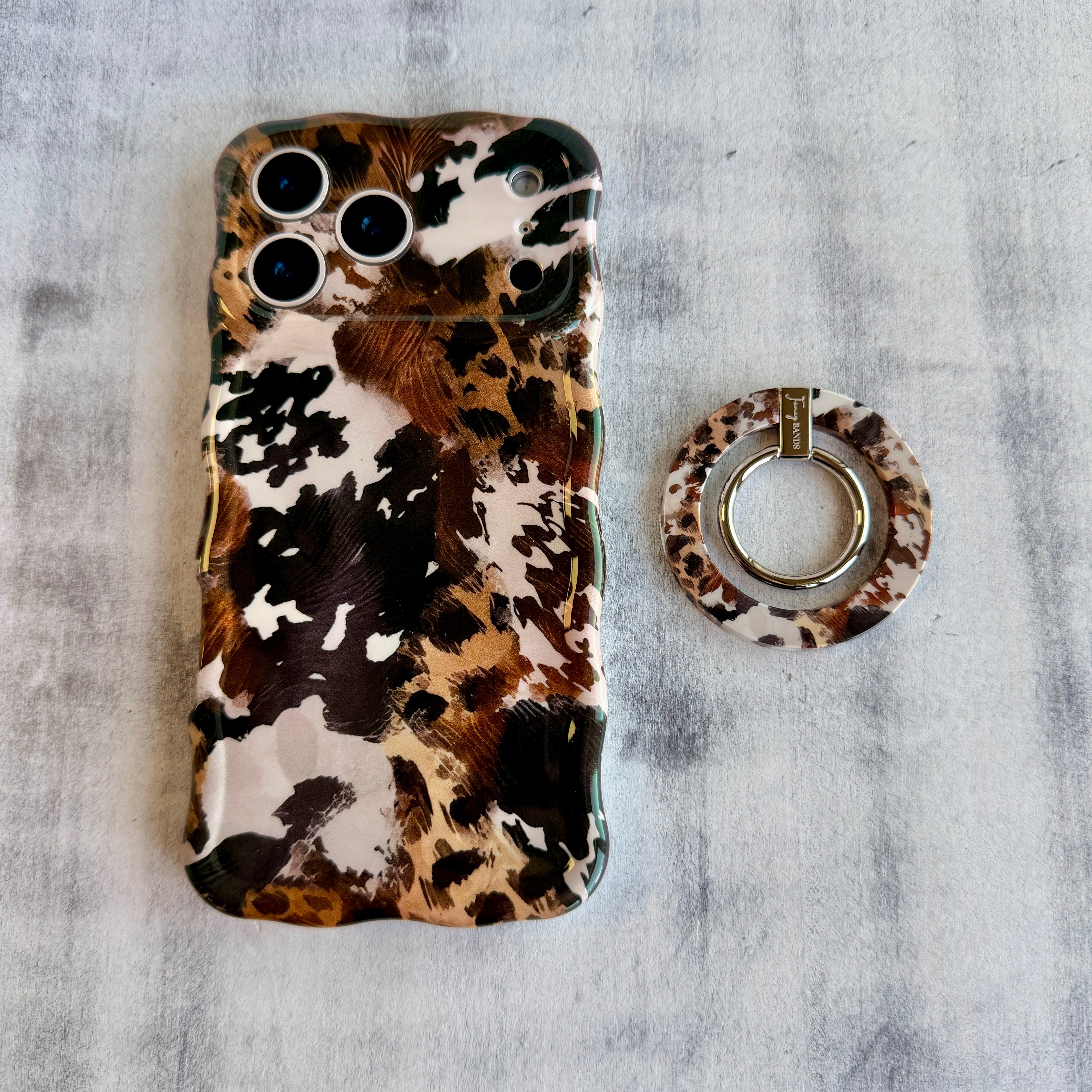 Rodeo Wild western cowhide pattern MagSafe phone grip ring with brown and black spots compatible with iPhone and Samsung