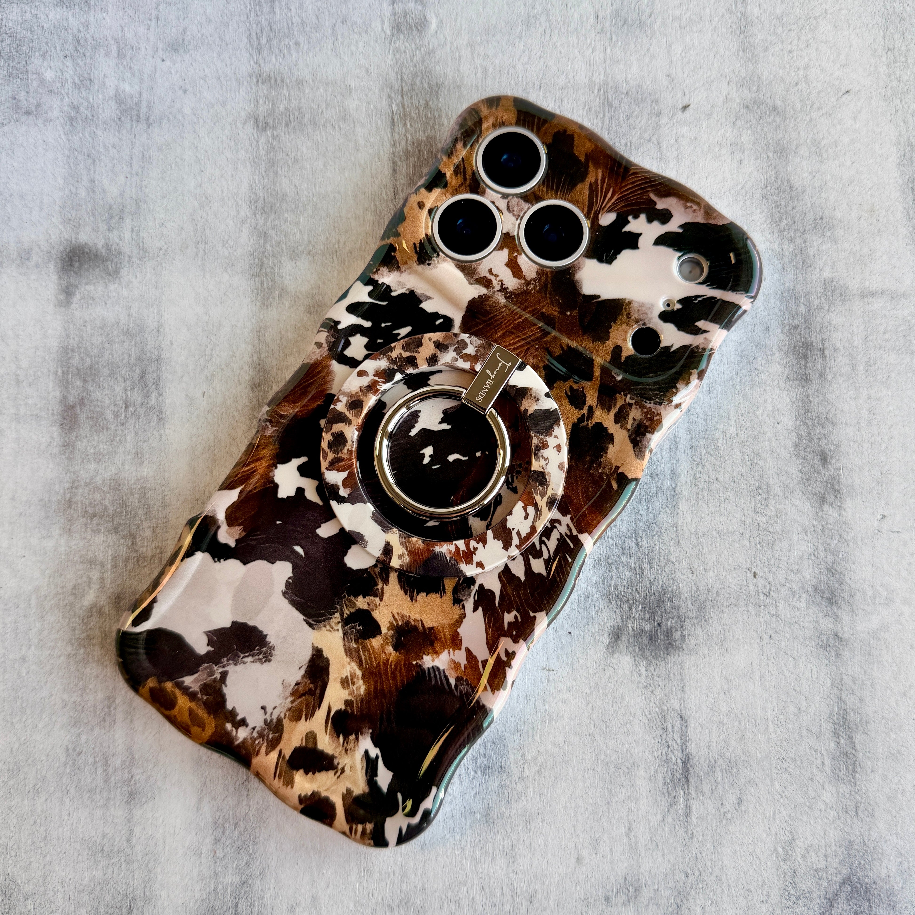 Rodeo Wild western cowhide pattern MagSafe phone grip ring with brown and black spots compatible with iPhone and Samsung