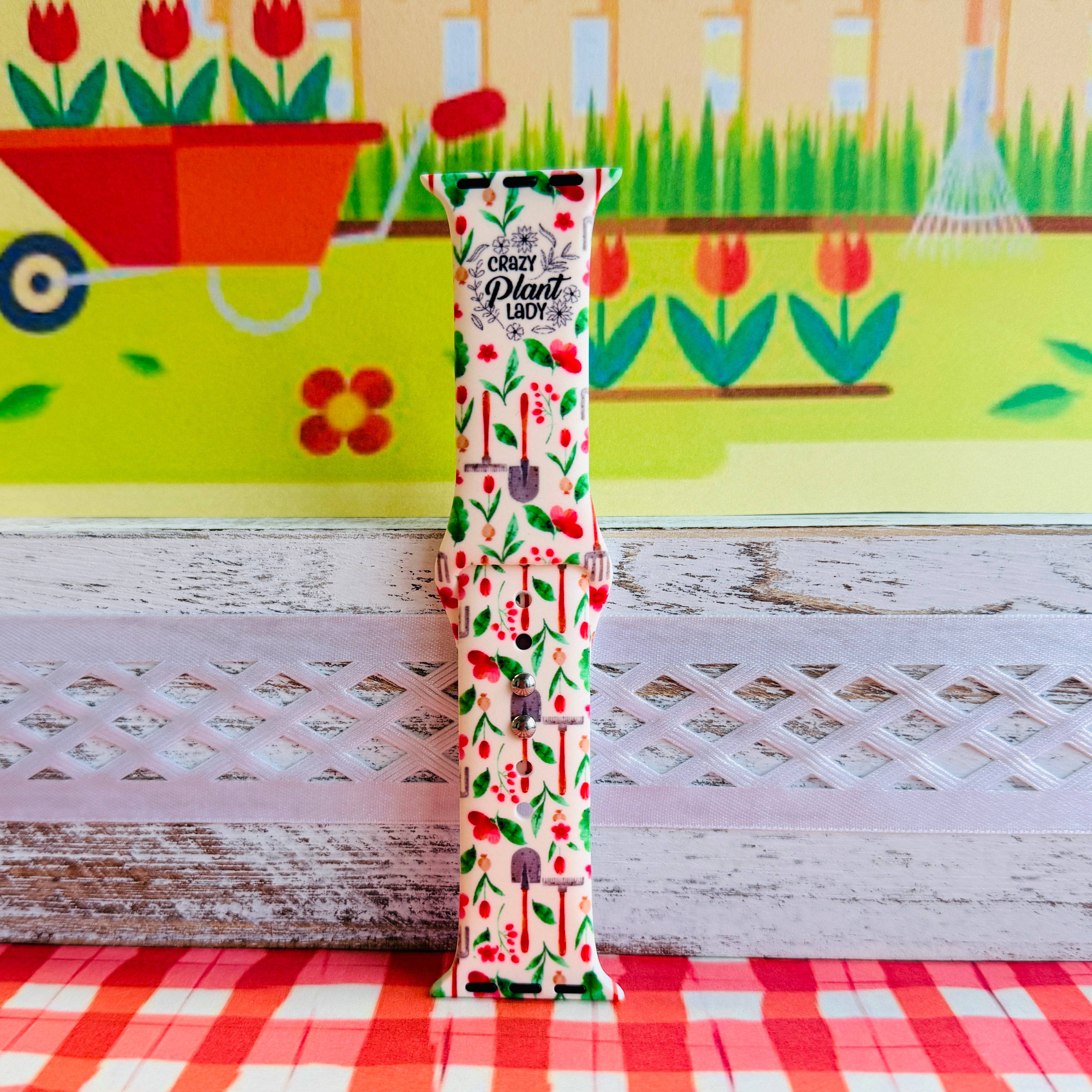 Crazy Plant Lady Apple Watch band with gardening tools, red flowers, and green leaves on cream background with garden decorations