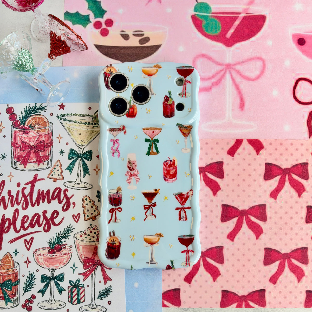 Holiday Spirits, Please? iPhone case lying on pink bow paper beside a Christmas, please cocktail print