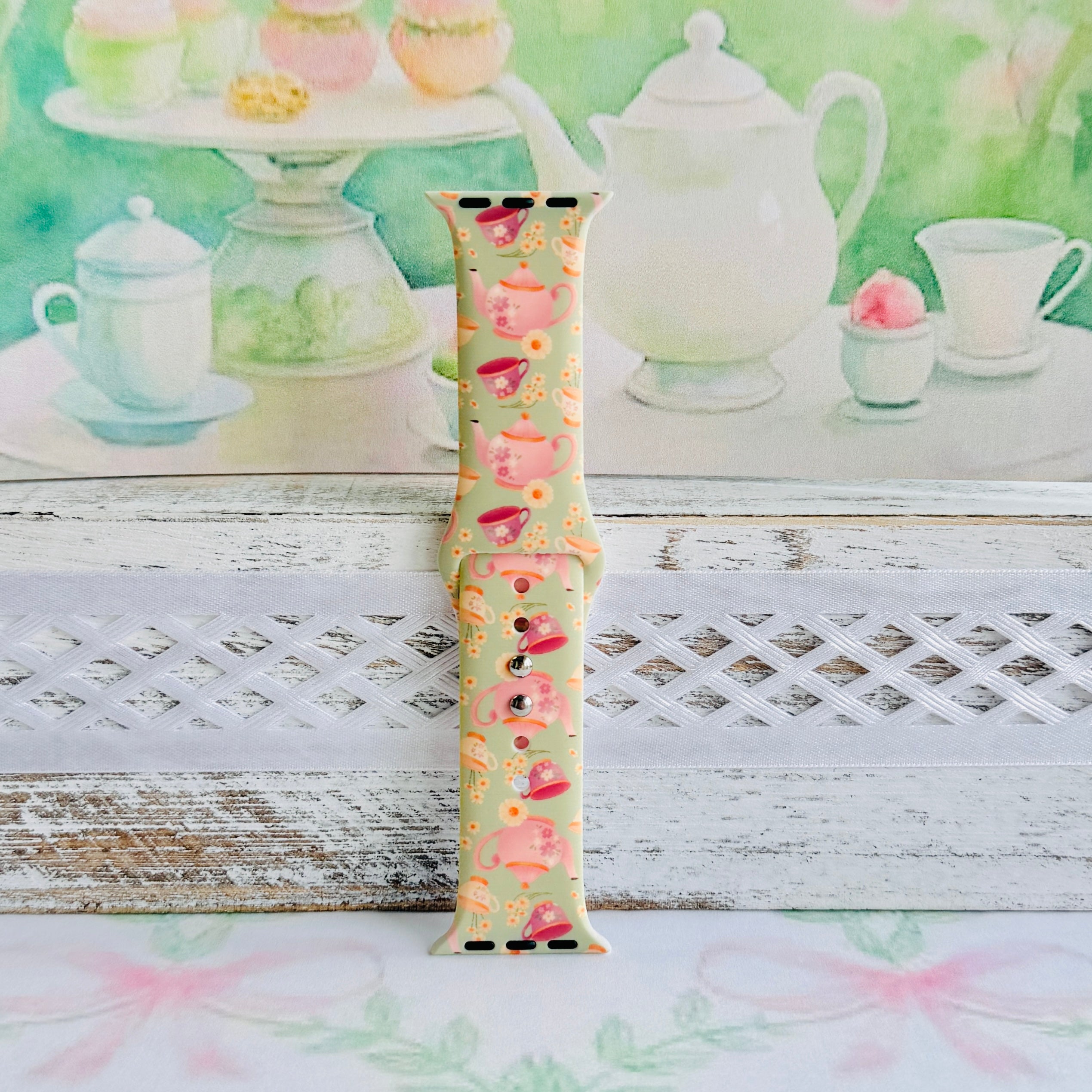 Tea Time Delight Apple Watch band with pink teapots and teacups on yellow-green background with watercolor tea party backdrop
