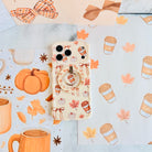 Falling in Love a Latte Hold It Fancy MagSafe grip ring with a cream coquette print of coffee cups, maple leaves, pumpkins and bows from Fancy Bands
