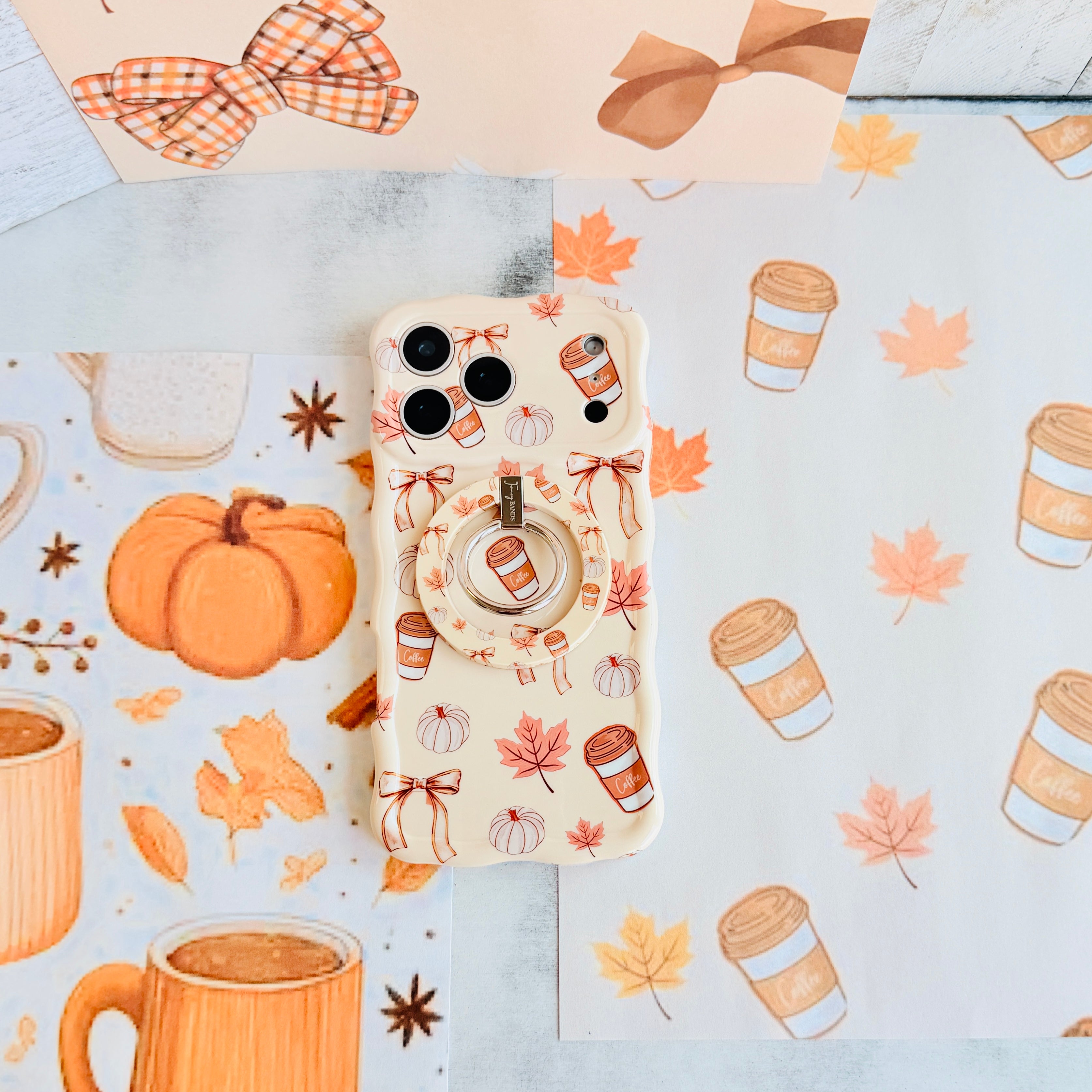 Falling in Love a Latte Hold It Fancy MagSafe grip ring with a cream coquette print of coffee cups, maple leaves, pumpkins and bows from Fancy Bands